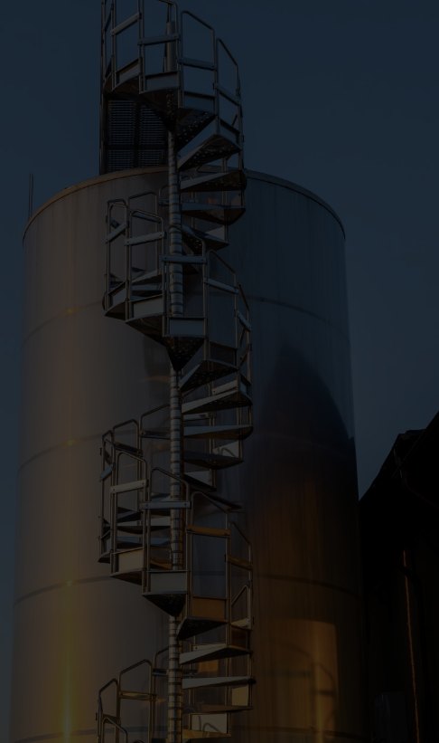 Grain silo with spiral staircase at dusk